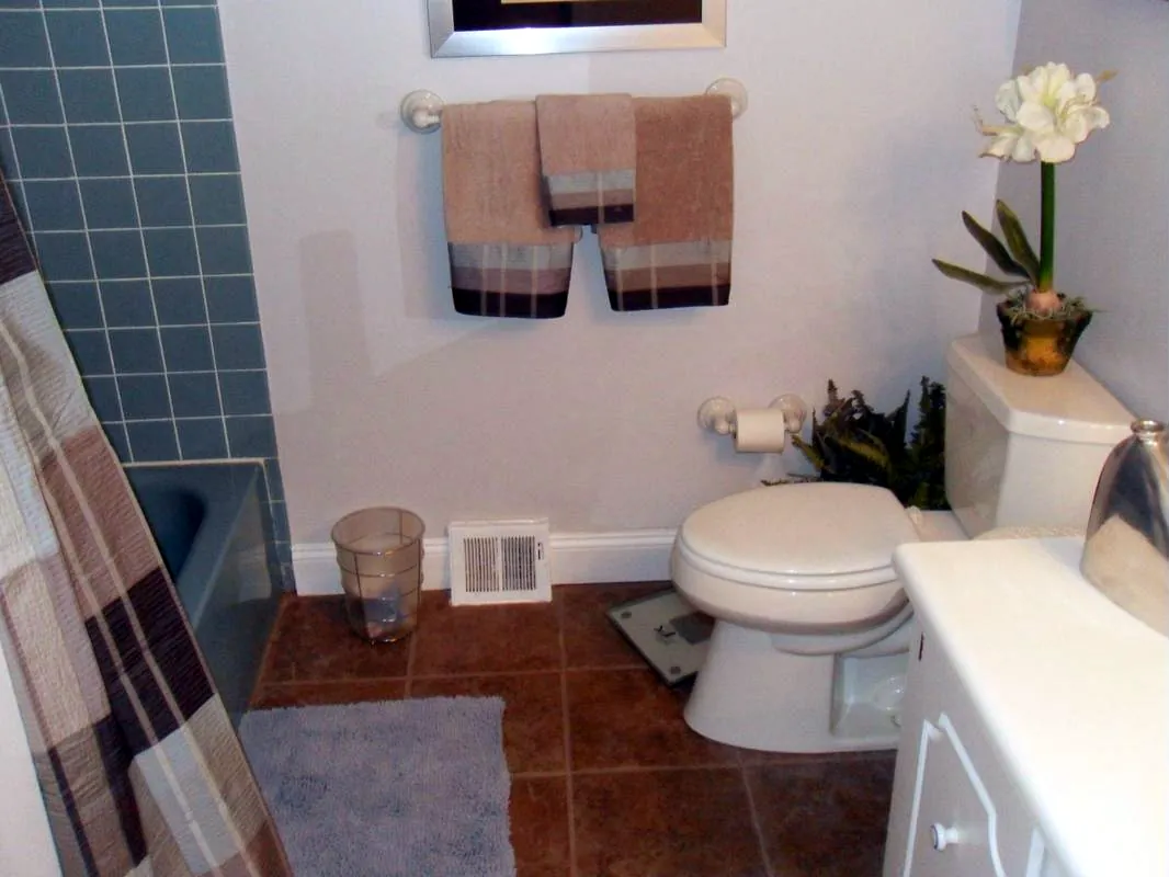Updated bathroom with tile floor, new toilet and fresh paint