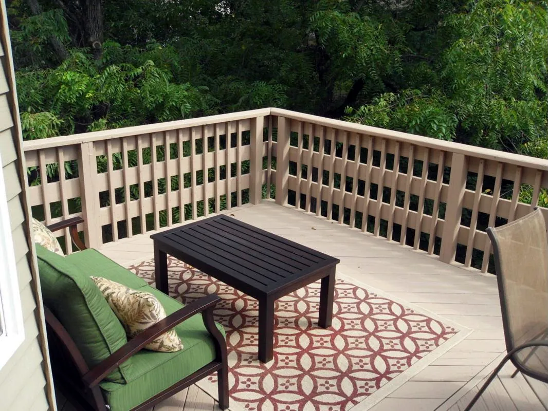 Painted deck with custom railing overlooking trees