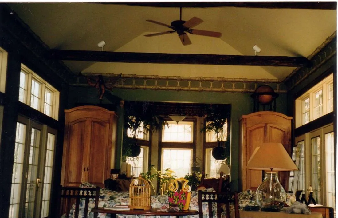 Sunroom with exposed beams, decorative frieze and painted walls